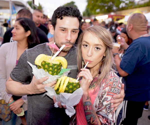 couple drinking a cocktail in a pineapple